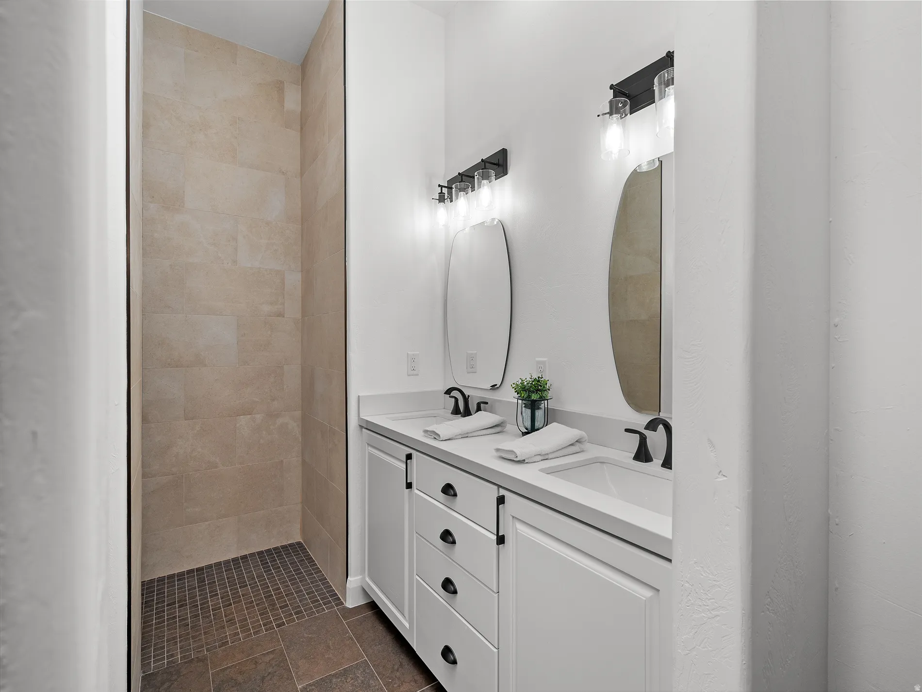 Dual vanity with white cabinetry and integrated sinks