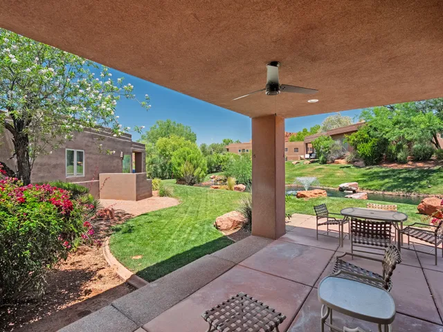 Covered patio with an outdoor ceiling fan, concrete flooring, and recessed lighting