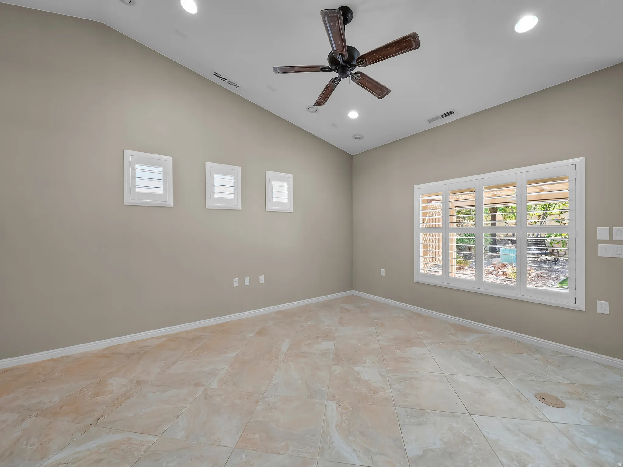 Vaulted ceiling featuring a dark wood-finish ceiling fan and recessed lighting