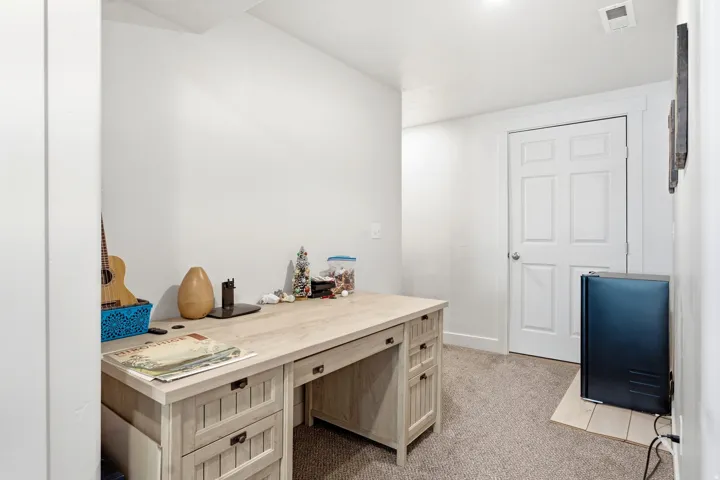 Recessed ceiling lighting, white paneled door, light-toned carpet, and white walls