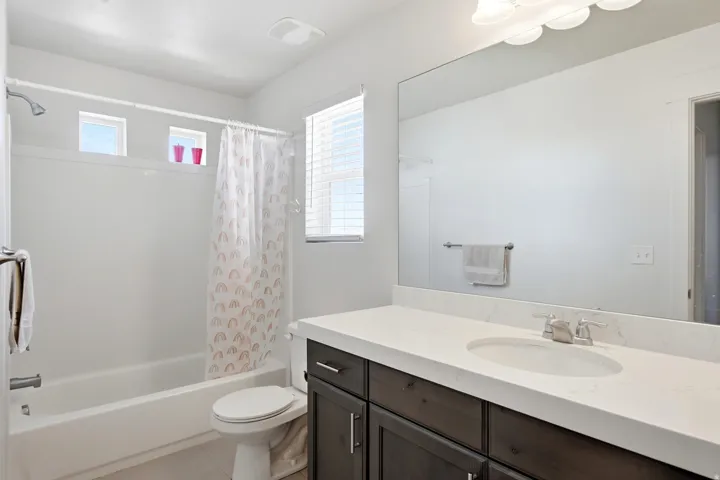 White bathtub and shower combination with a single shower head