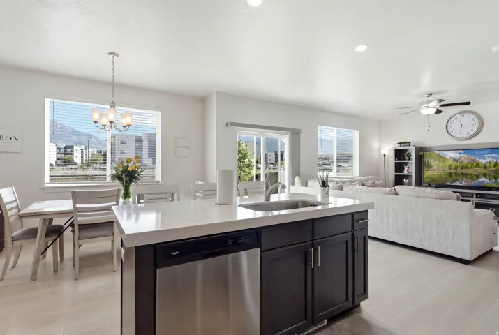 Open-concept living space featuring light wood-finish flooring, recessed lighting, and a contemporary ceiling fan