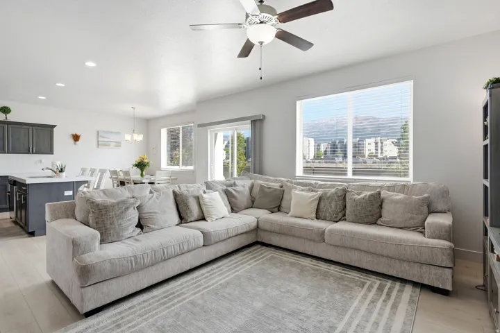 Open-concept living space featuring wood-finish flooring and a ceiling fan