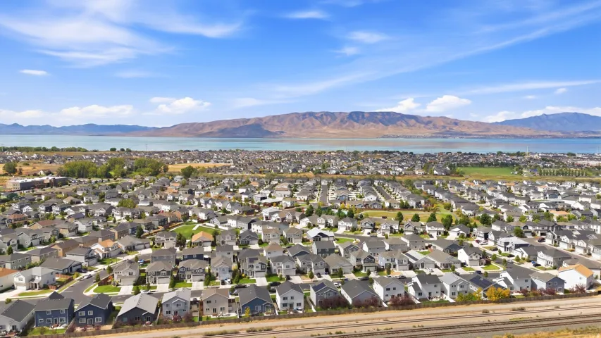 Expansive residential community with a mountain and lake backdrop