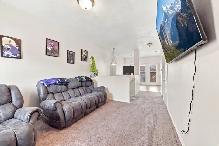 Wall-to-wall carpeting throughout, light-toned walls, and a ceiling-mounted light fixture