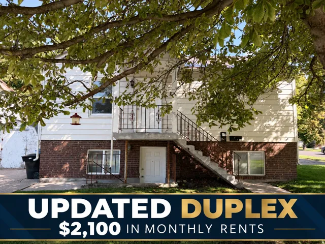 Real Estate Listing Image. Depicting the property with a text overlay indicating "UPDATED DUPLEX" and "$2,100 IN MONTHLY RENTS"