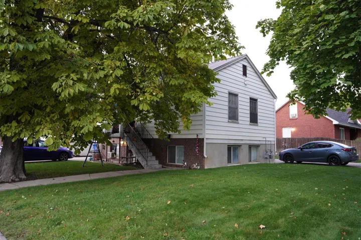 Siding exterior with brick foundation and a gabled roof
