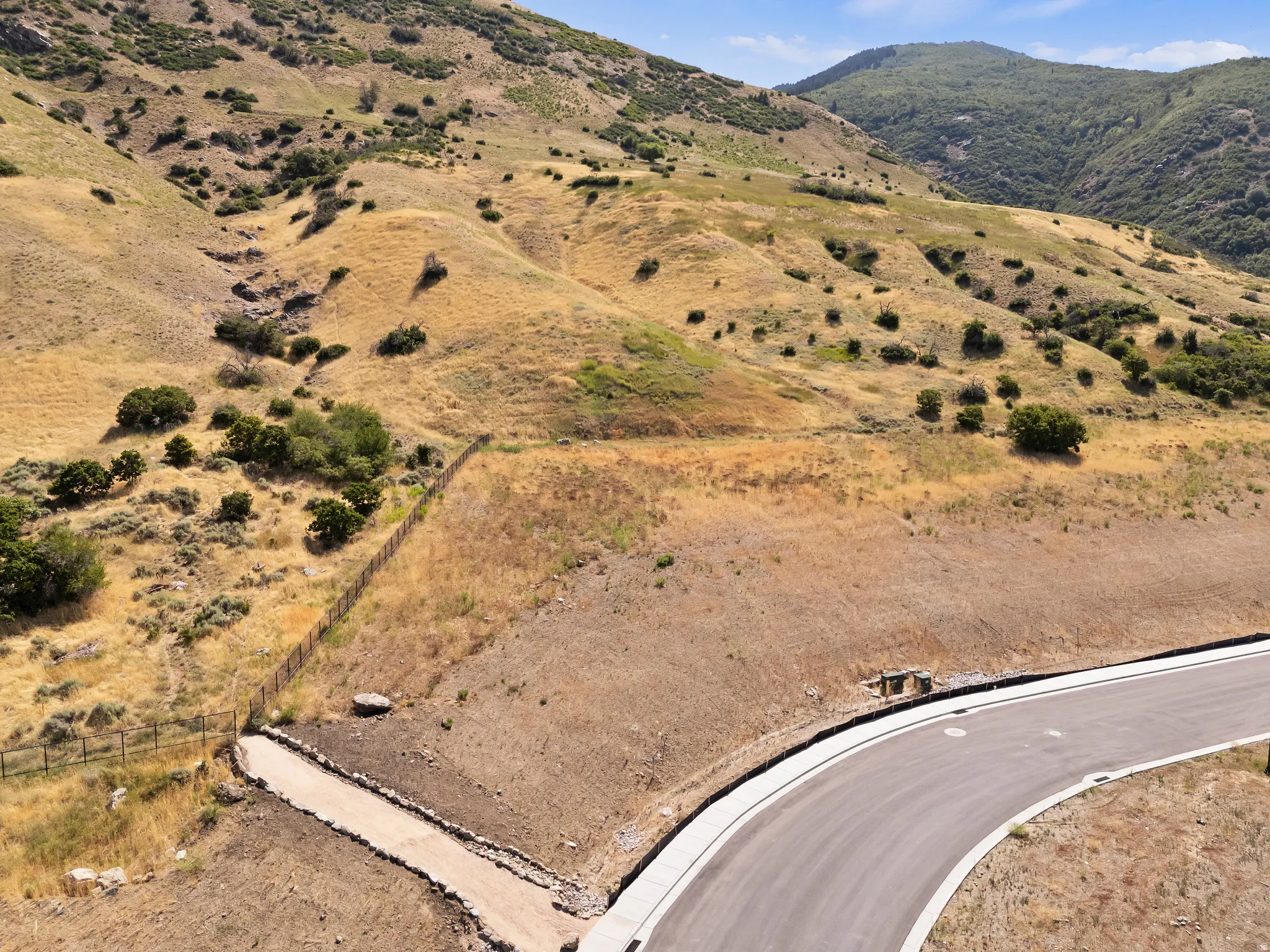 Newly paved asphalt road with concrete curbing