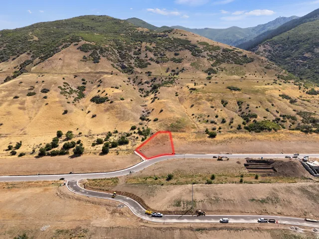 Property parcel with paved road frontage and mountain backdrop
