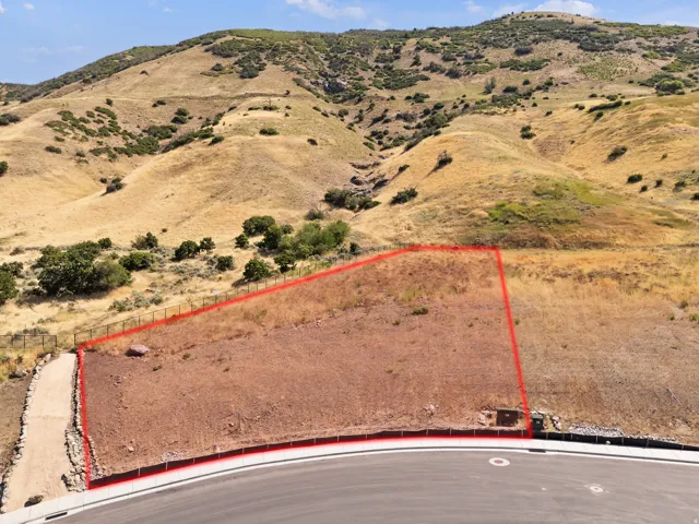 Graded lot with a paved road frontage and mountain backdrop