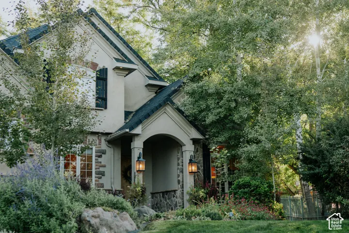 Stucco and stone exterior with arched entryway