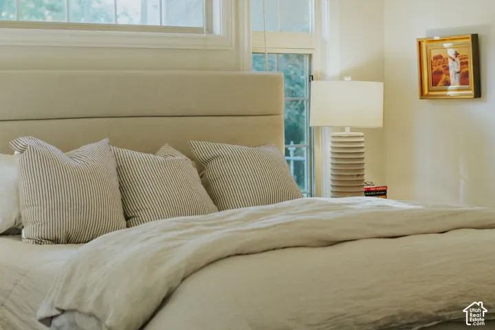 Upholstered headboard with an integrated window, featuring an attached lighting fixture