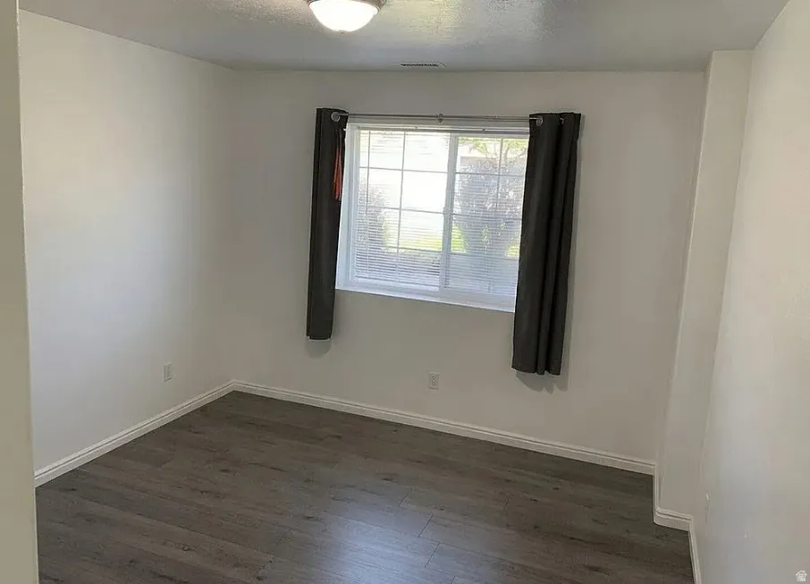 LPV finish flooring, white walls, and a window with blinds