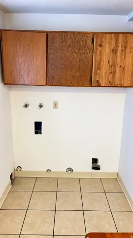 Wood-finish upper cabinetry and tiled flooring