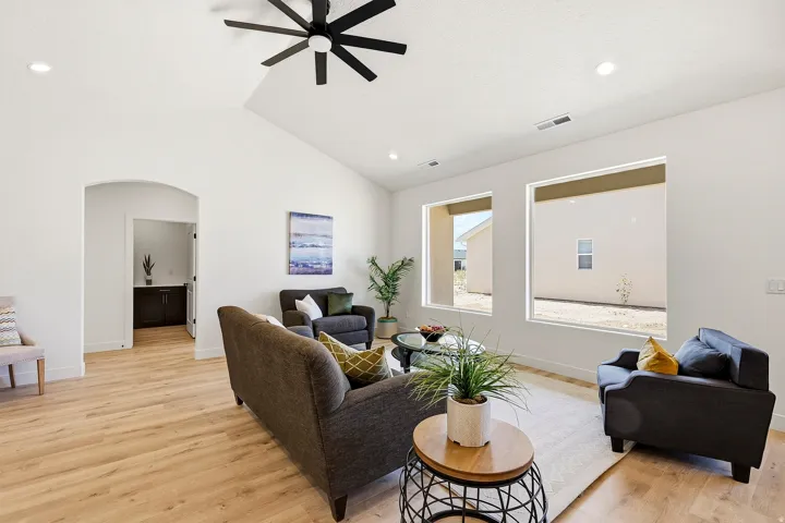 Vaulted ceilings with a ceiling fan, recessed lighting, wood-finish flooring, and multiple large windows