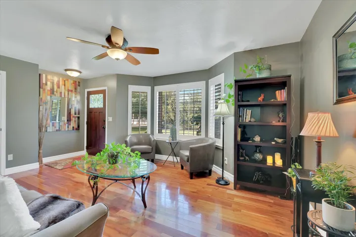 Warm wood-finish flooring with a multi-paneled entry door
