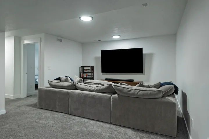 Recessed ceiling lighting illuminates the carpeted floor