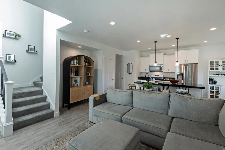 Open-concept kitchen with white cabinetry and stainless steel appliances