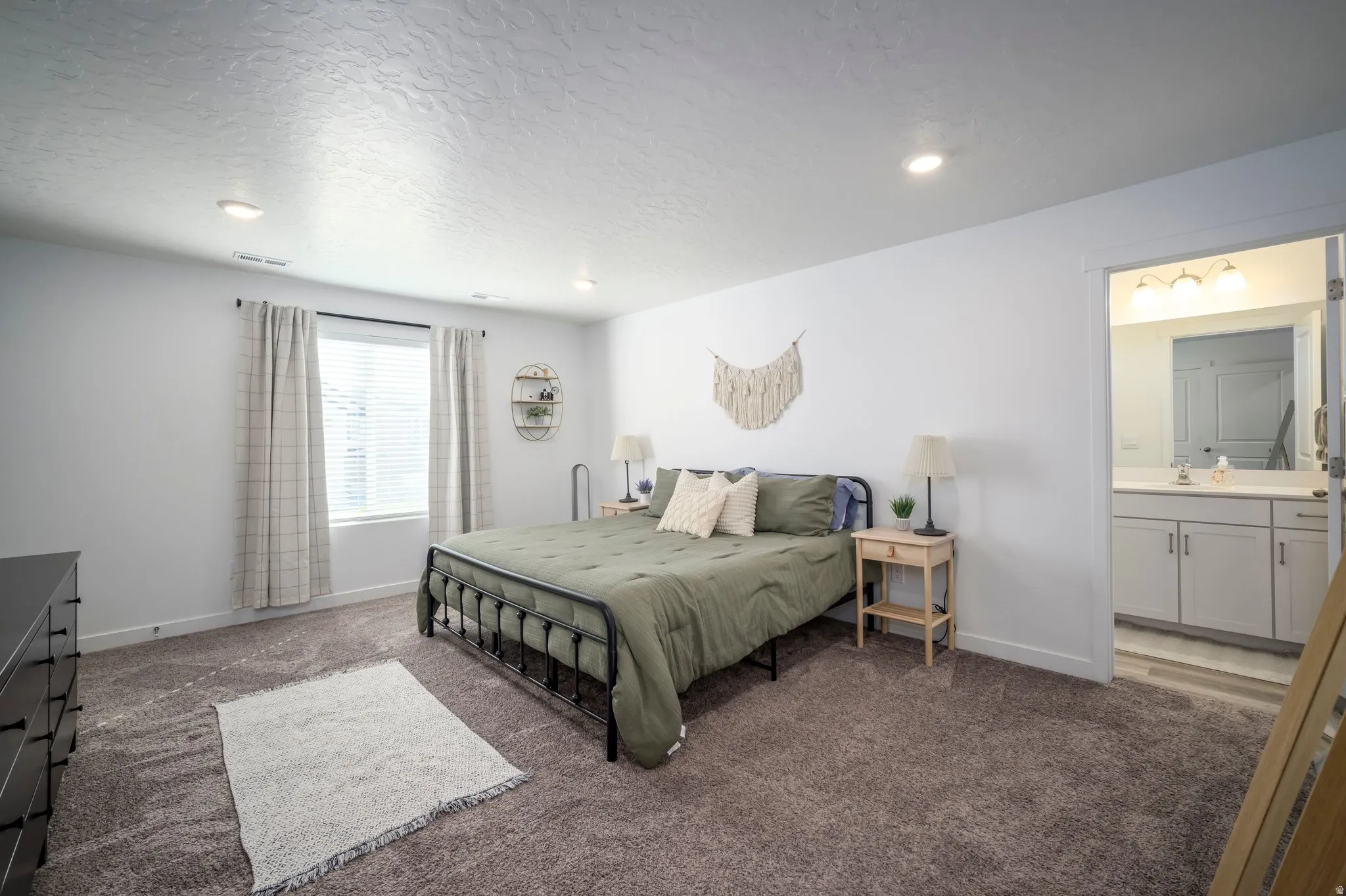 Master bedroom with recessed ceiling lighting, window with blinds, and carpeted flooring