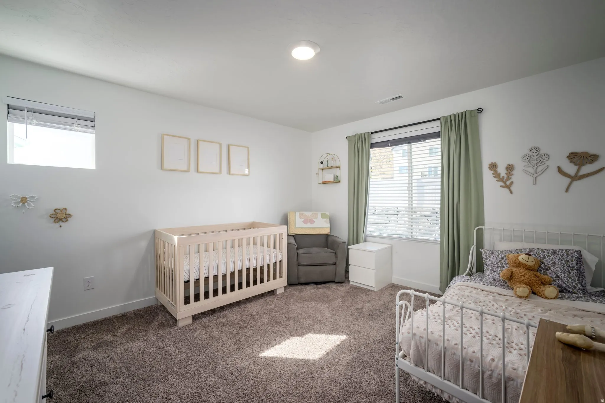 Plush carpet flooring, recessed lighting, and multiple windows with blinds