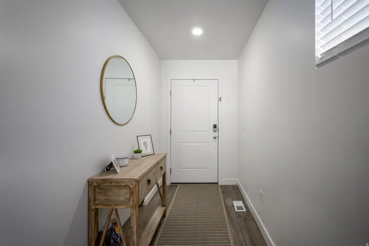 Entryway featuring light wood-finish flooring, recessed lighting, and a window with blinds