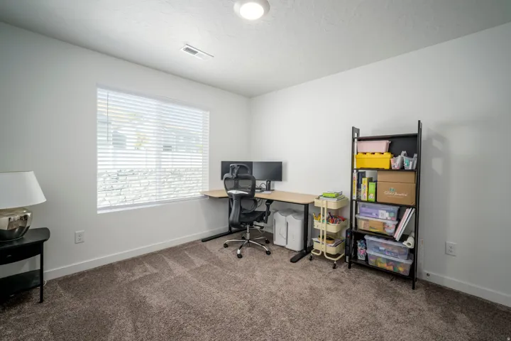 Neutral wall finishes, textured carpeting, and window blinds