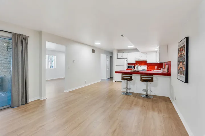 Wood-finish flooring, white walls, and a sliding glass door