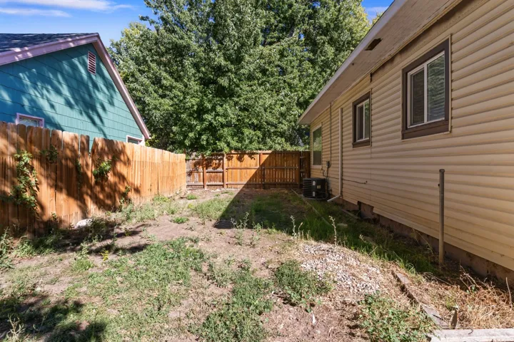 Outdoor space featuring a privacy fence and mature trees