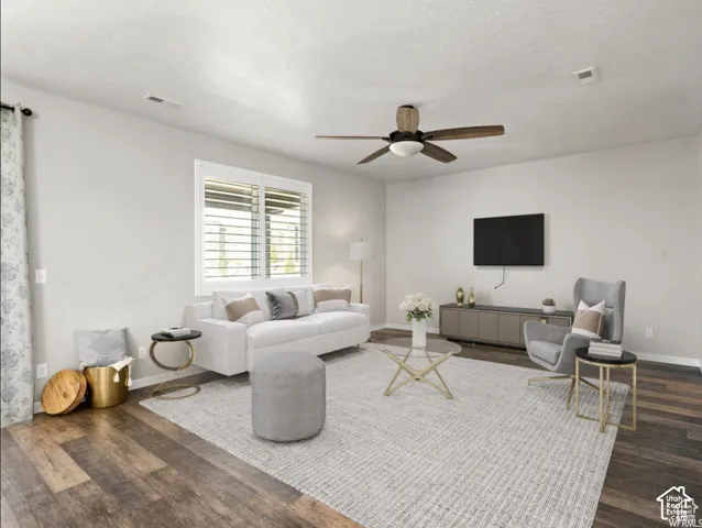 Wood-finish flooring, white walls, and a ceiling fan with integrated lighting