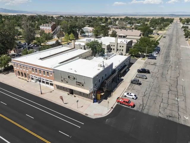Multi-story commercial building with brick facade and large storefront windows