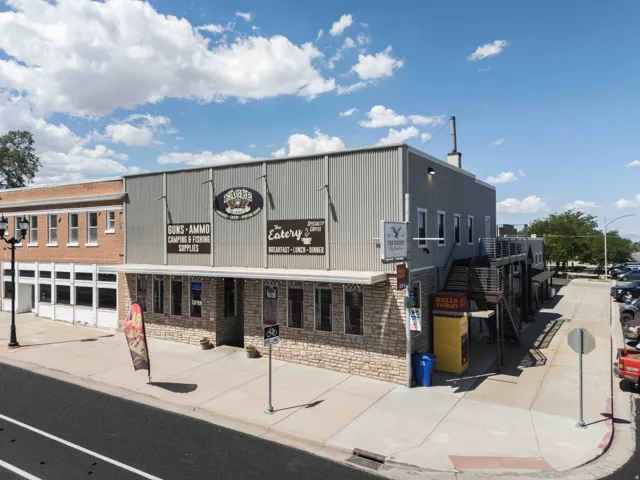Commercial building with a stone-finish facade and corrugated metal siding