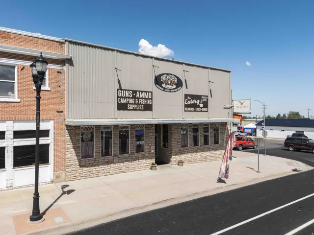 Commercial building featuring a brick facade, corrugated metal siding, and stone-finish lower exterior