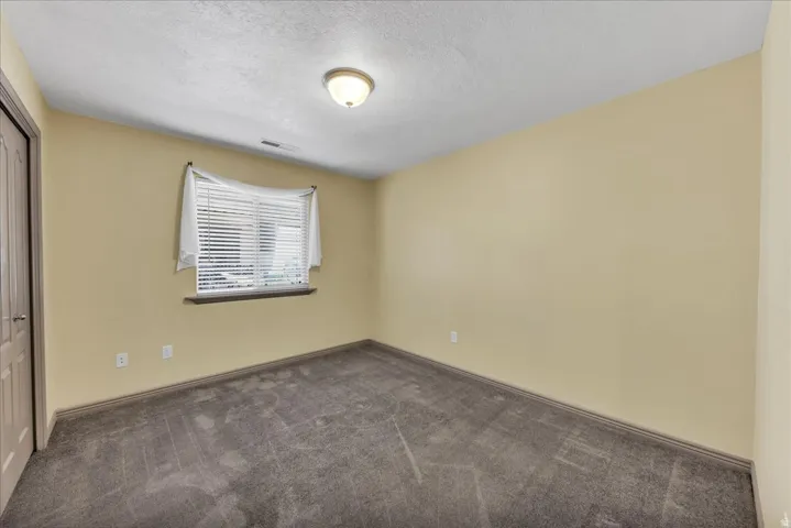 Neutral-toned walls complement plush carpeting
