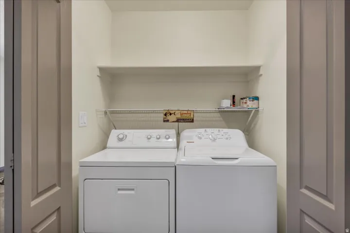 Dedicated laundry alcove featuring a built-in wire shelving unit and a single wall shelf