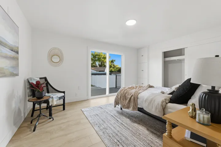 White walls, recessed lighting, wood-finish flooring, sliding glass door, and built-in closet
