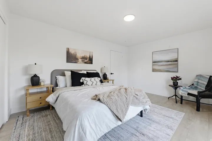 Recessed ceiling lighting, light wood-finish flooring, and white walls