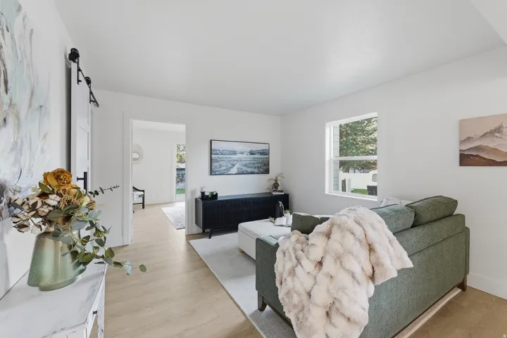 Light-toned wood-finish flooring complements white wall finishes