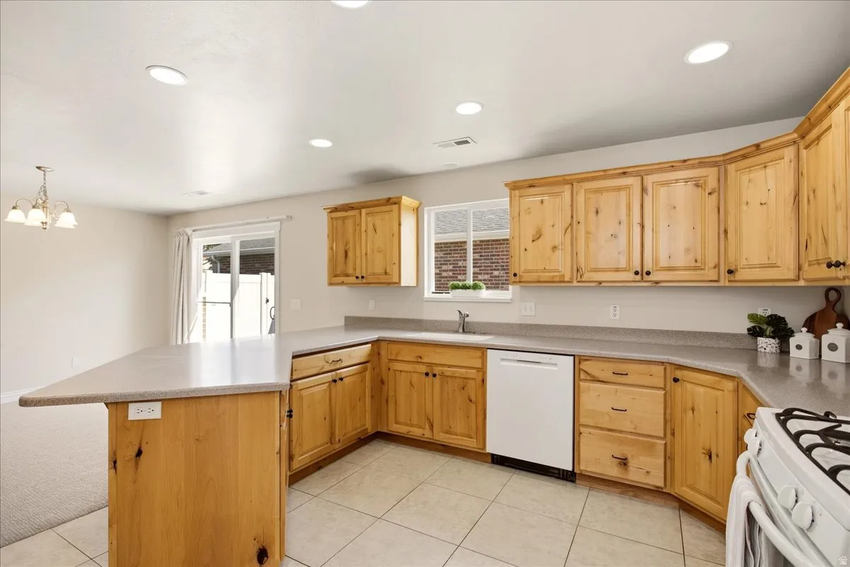 Spacious kitchen featuring light wood cabinetry, light countertops, and tile flooring