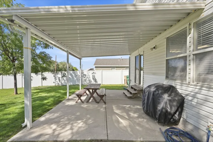 Covered patio with aluminum louvered roof system offering adjustable shade and weather protection