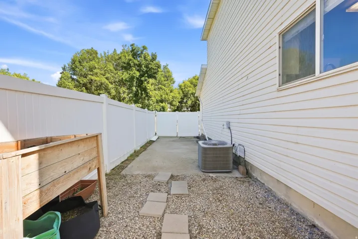 White vinyl fencing enclosing a gravel and concrete patio area