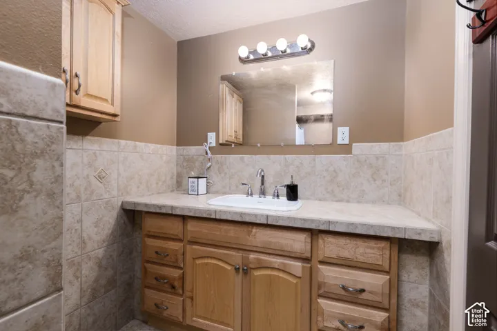 Wood-finish vanity with an integrated sink and chrome faucet