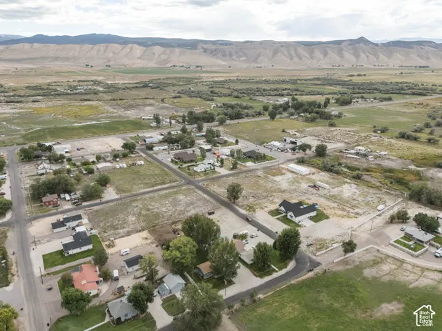 Expansive landscape with a distant mountain range and a mix of residential and undeveloped parcels