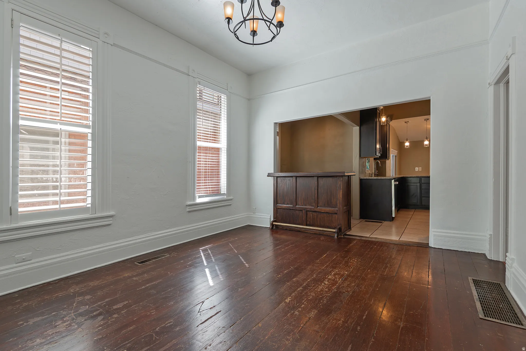 Hardwood flooring throughout, with plantation shutters on multiple windows