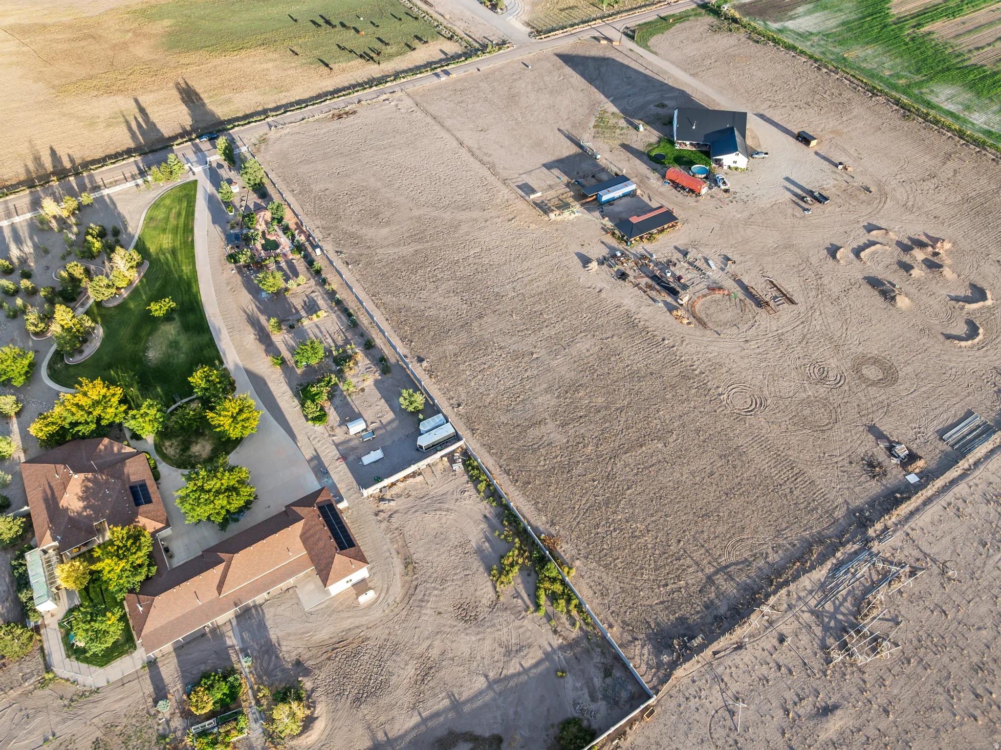 Expansive property featuring multiple structures, open land areas, and developed landscaping