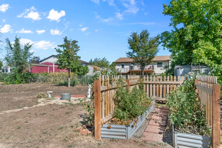 Defined garden beds with wood fencing