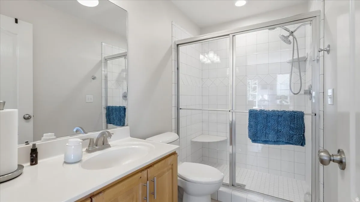 Light wood-finish vanity with a white countertop and rectangular sink