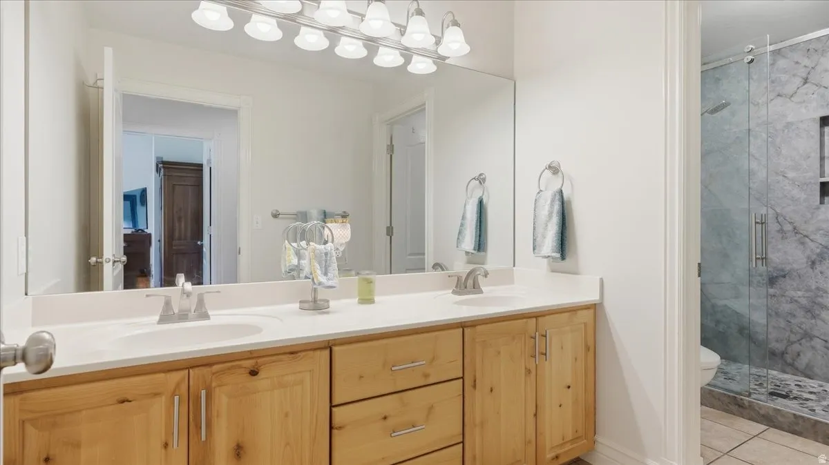 Double vanity with wood cabinetry and light-colored countertops