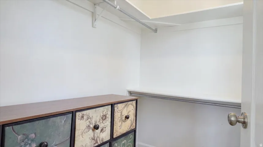 Built-in shelving and dual hanging rods provide storage