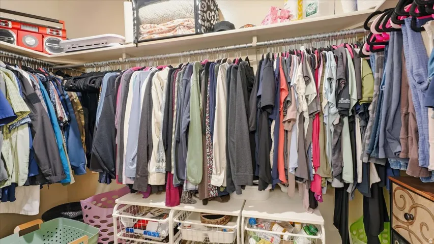 Built-in shelving with multiple hanging rods and storage racks