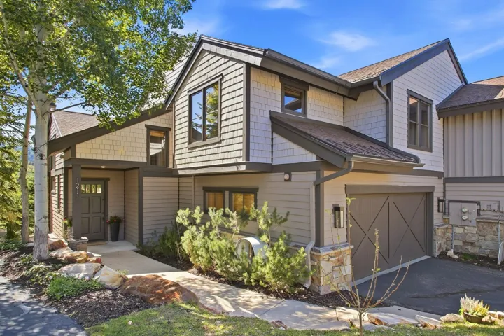 Multi-level exterior featuring shingle siding and dark trim